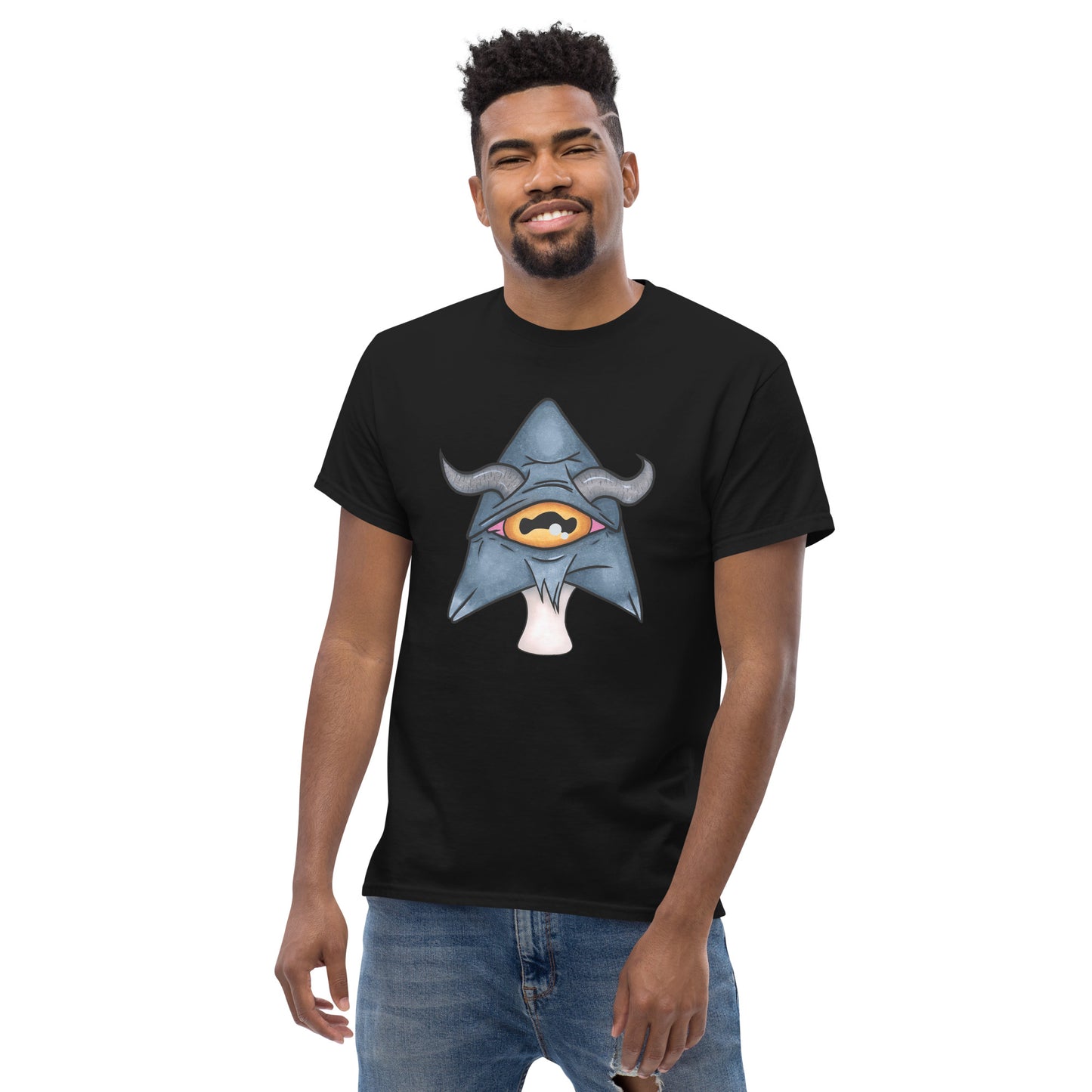 male model wears black mens tee featuring a trippy grey goat mushroom design with one yellow eye