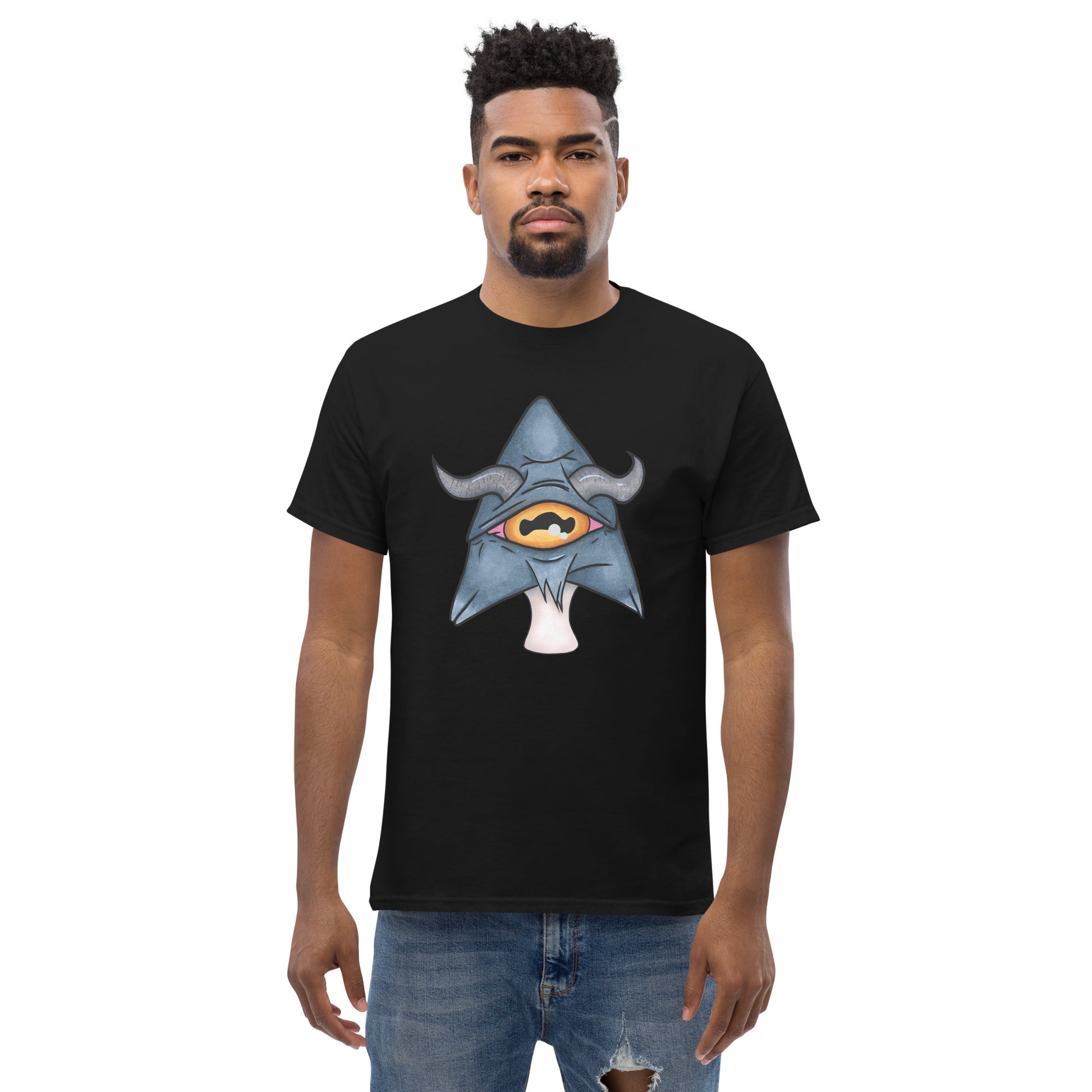 male model wears black mens tee featuring a trippy grey goat mushroom design with one yellow eye