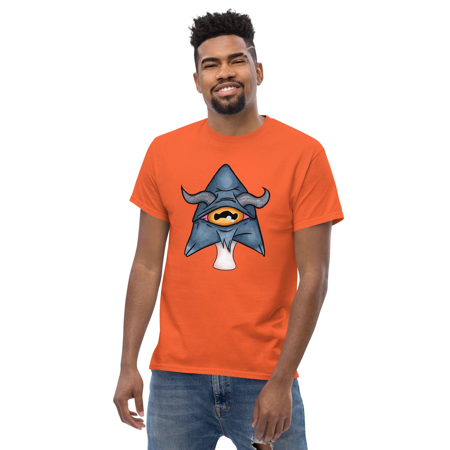 male model wears orange mens tee featuring a trippy grey goat mushroom design with one yellow eye