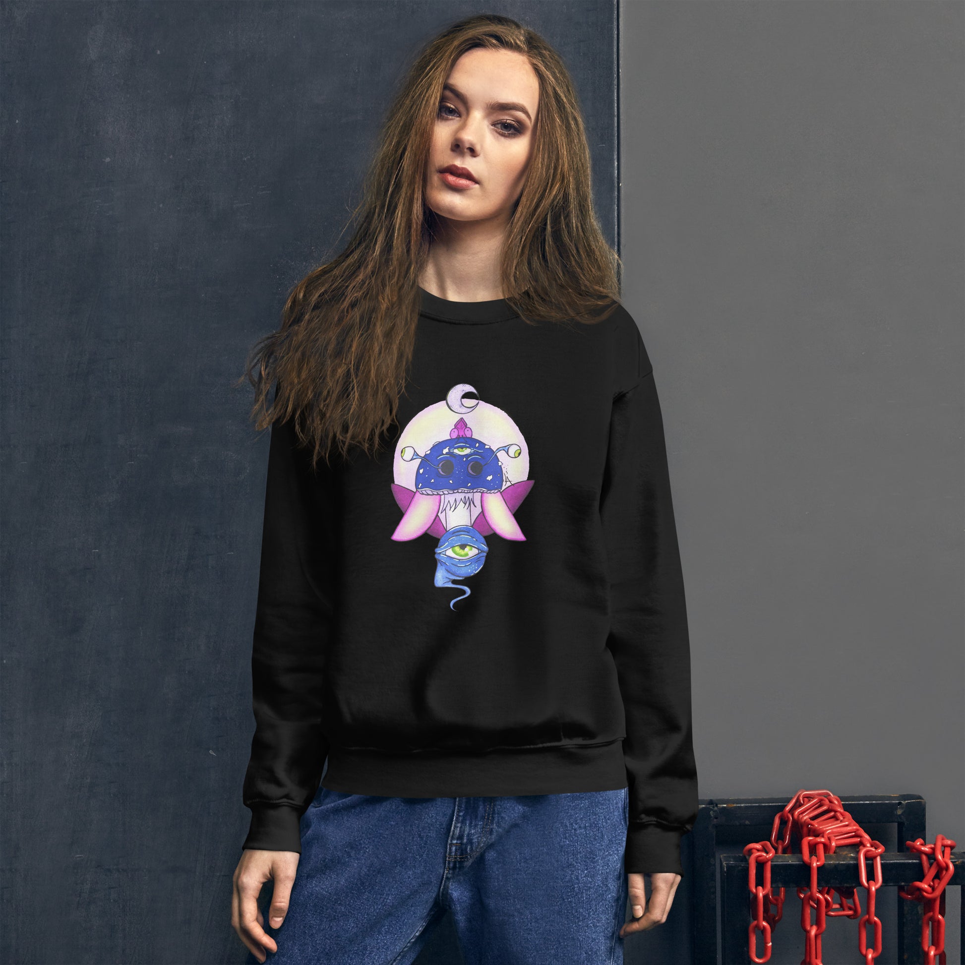 Female model wears Unisex black crew neck sweatshirt with mystical print featuring a multi-eyed mushroom, insect wings, and a watchful eye.