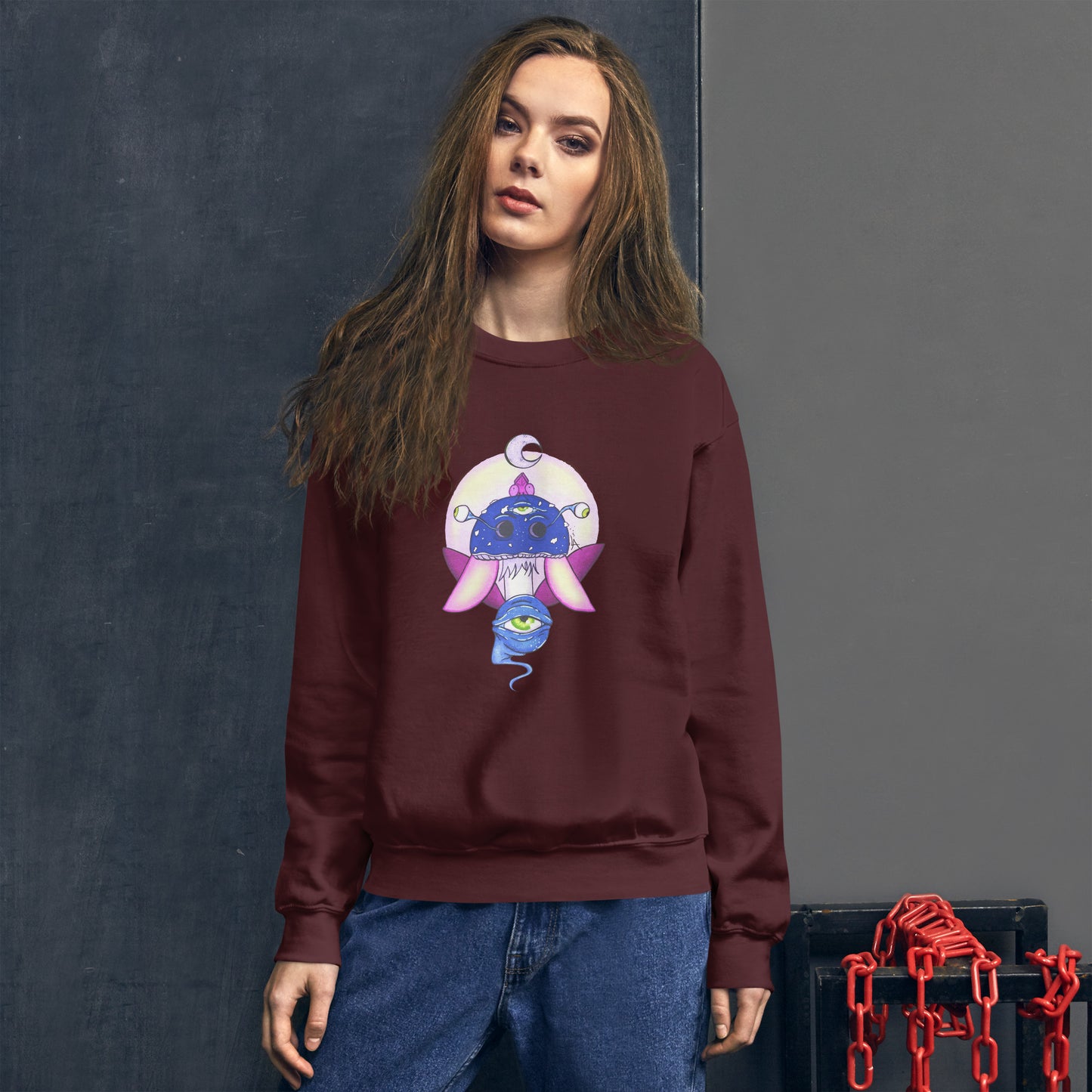 female model wears Unisex maroon crew neck sweatshirt with mystical print featuring a multi-eyed mushroom, insect wings, and a watchful eye.