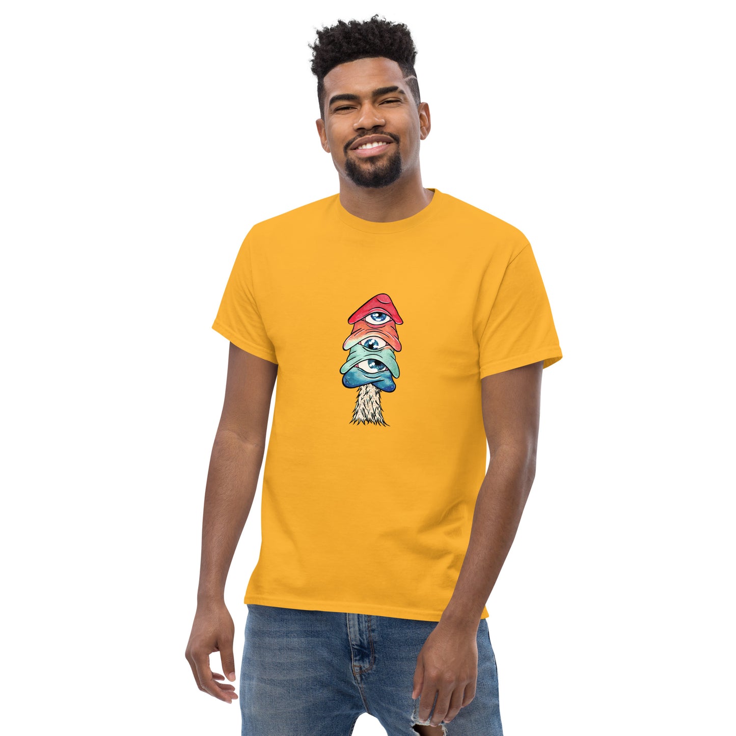 male wears gold crew neck tshirt mushroom with 3 eyes in pink green and blue