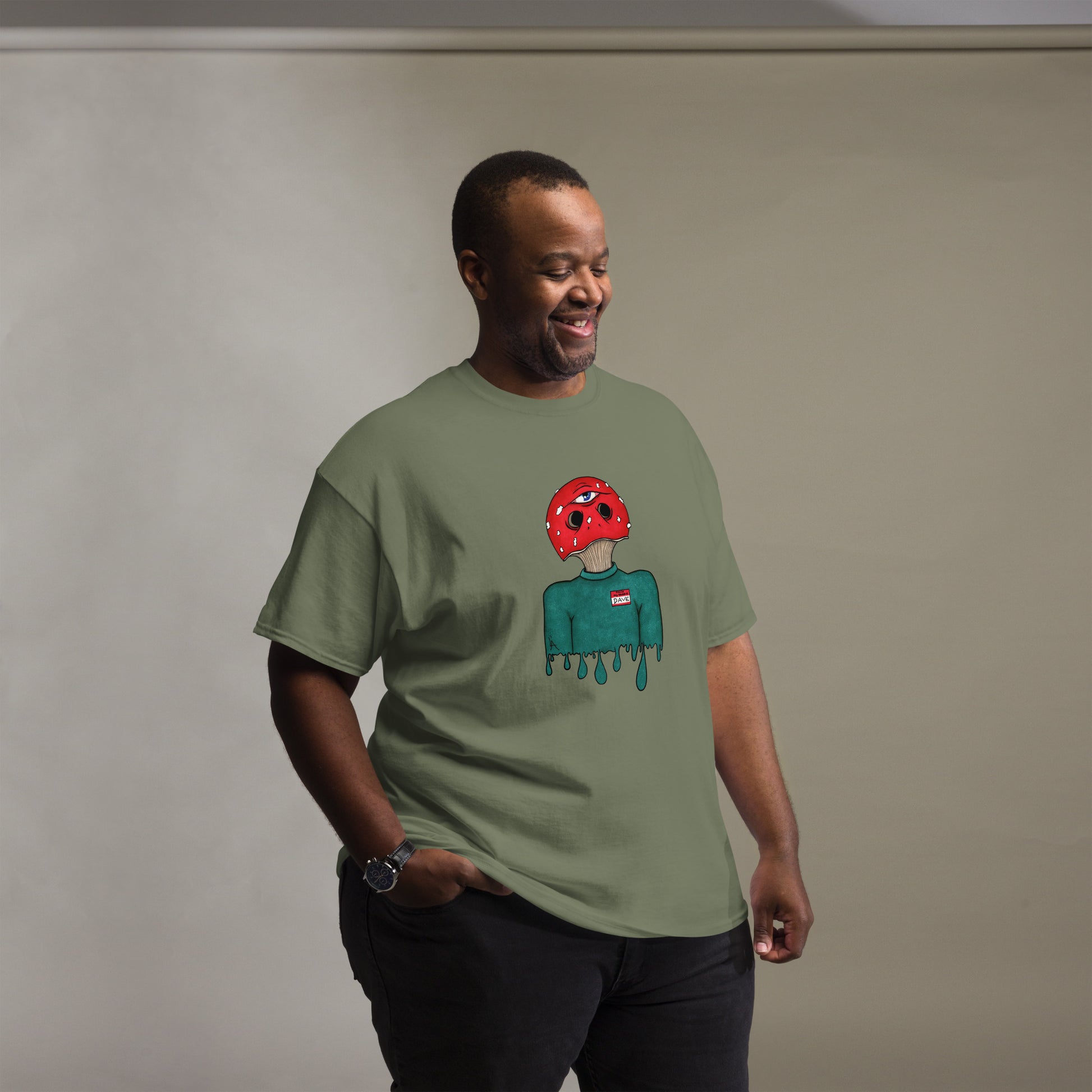 male wears trippy toadstool mushroom man named Dave printed on a military green crew neck t-shirt