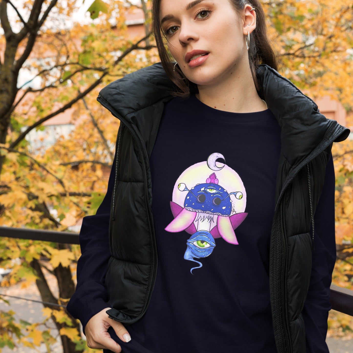 female wears navy long sleeve tee psychedelic toadstool mushroom with eyes full moon crescent moon flying insect in winter blue and purple