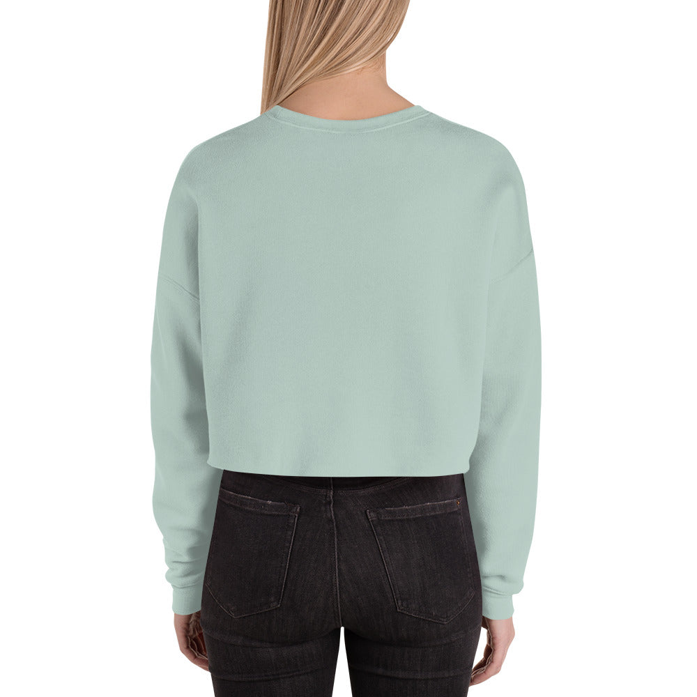 female wears dusty blue crop sweatshirt back view