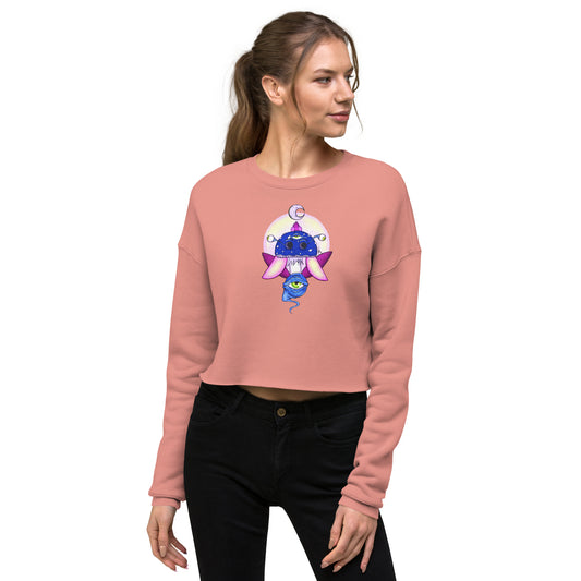 female wears mauve crop sweatshirt with psychedelic toadstool mushroom with eyes full moon crescent moon flying insect design in winter blue and purple